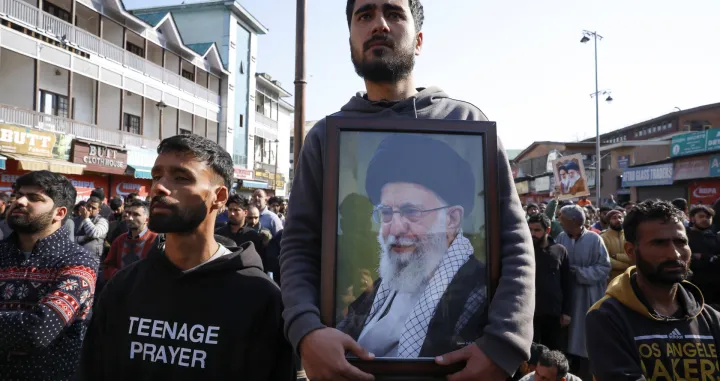 A Shiite Muslim man holds a photo of Iran's Supreme Leader Ayatollah Ali Khamenei, as they protest after Khamenei was killed in Israeli-U.S. strikes on Saturday, in Srinagar, Indian Kashmir March 1, 2026. REUTERS/Sharafat Ali/Sharafat Ali