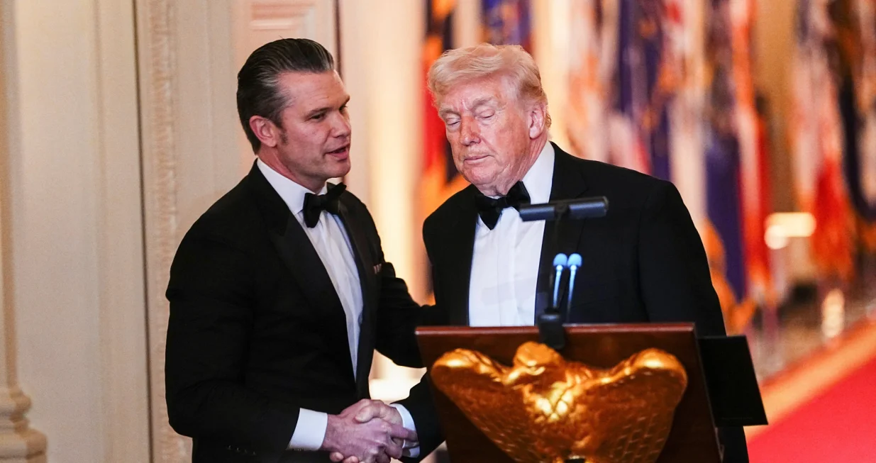 U.S. Secretary of Defense Pete Hegseth and U.S. President Donald Trump shake hands during a Governors Dinner at the White House in Washington D.C., U.S., February 21, 2026. REUTERS/Aaron Schwartz/Aaron Schwartz