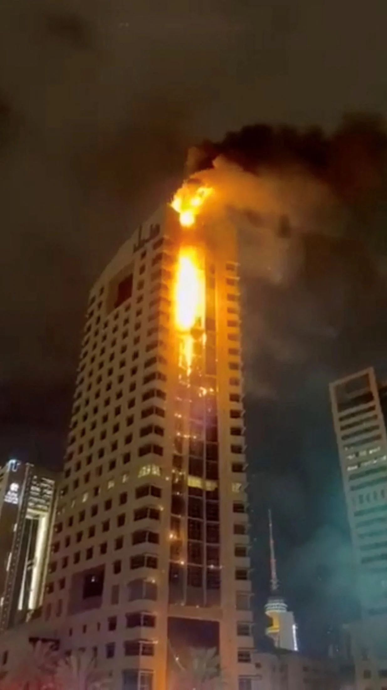 Smoke rises from a building on fire, in the aftermath of what the Kuwaiti Army says is a drone attack, amid the U.S.-Israeli conflict with Iran, in Kuwait City, Kuwait March 8, 2026 in this screengrab taken from a social media video. SOCIAL MEDIA/via REUTERS THIS IMAGE HAS BEEN SUPPLIED BY A THIRD PARTY. NO RESALES. NO ARCHIVES. VERIFICATION: Reuters was able to confirm the location from buildings, road layout, road signs and the bridge which matched file image and satellite images. Coordinates of the building being hit were at 29.362763799479662, 47.98382949072929. Reuters was able to confirm the date of the video from government statements and local news reports. Kuwait military wrote on X that some civilian facilities were damaged, and the General Organization for Social Insurance confirmed that the main building of the organization was targeted on March 8./Social Media
