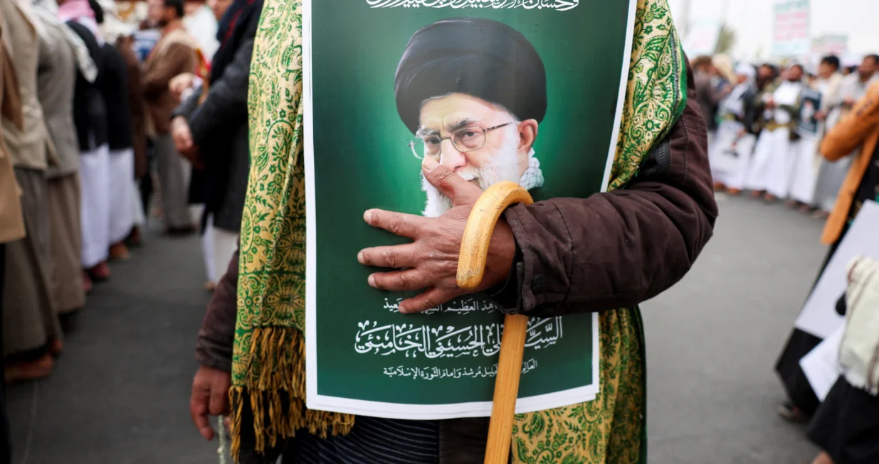 A man holding a poster featuring a picture of late Iran's Supreme Leader Ayatollah Ali Khamenei joins a demonstration with Houthi supporters in solidarity with Iran and Lebanon, amid the U.S.-Israeli conflict with Iran, in Sanaa, Yemen March 6, 2026. REUTERS/Khaled Abdullah/Khaled Abdullah