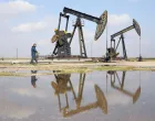 A man walks next to pumpjacks on the day a Syrian government delegation visits the oil-rich city of Rmelan to inspect oil fields and finalise agreements signed between the Syrian government and the Syrian Democratic Forces (SDF), in Rmelan, Syria, February 9, 2026. REUTERS/Orhan Qereman/Orhan Qereman