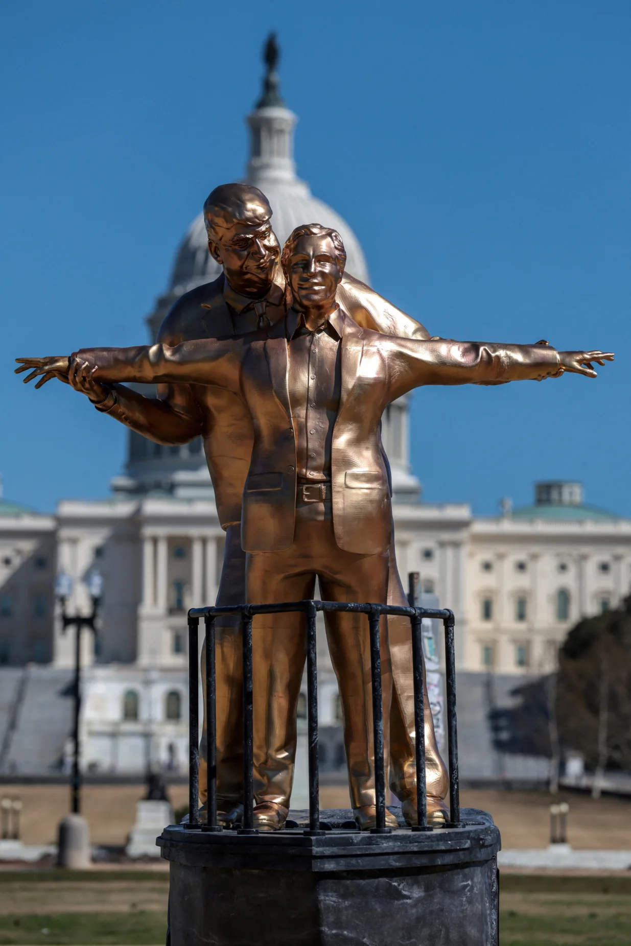 People look at a statue depicting U.S. President Donald Trump and convicted sex offender Jeffrey Epstein, entitled "The King of the World", on the National Mall in Washington, D.C., U.S., March 10, 2026. REUTERS/Evelyn Hockstein/Evelyn Hockstein