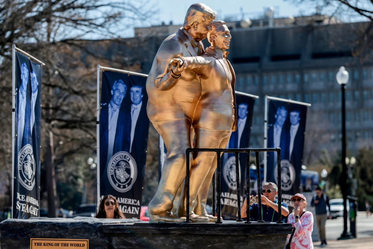 People look at a statue depicting U.S. President Donald Trump and convicted sex offender Jeffrey Epstein, entitled "The King of the World", on the National Mall in Washington, D.C., U.S., March 10, 2026. REUTERS/Evelyn Hockstein/Evelyn Hockstein