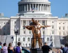 People look at a statue depicting U.S. President Donald Trump and convicted sex offender Jeffrey Epstein, entitled "The King of the World", on the National Mall in Washington, D.C., U.S., March 10, 2026. REUTERS/Evelyn Hockstein/Evelyn Hockstein