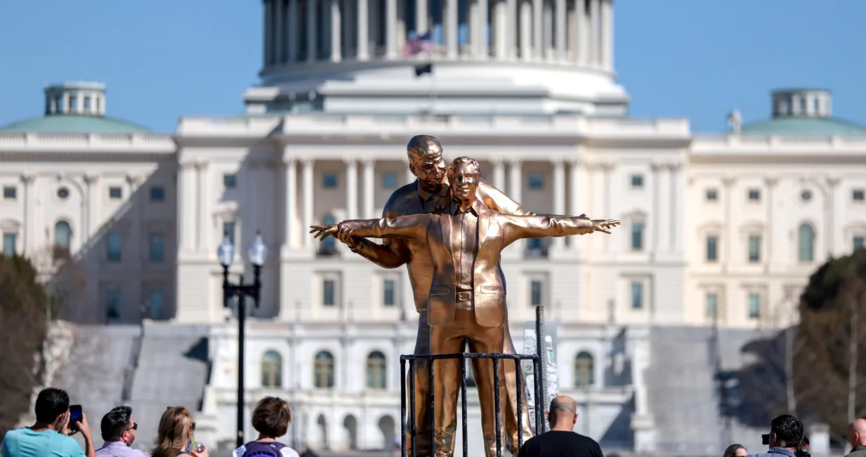 People look at a statue depicting U.S. President Donald Trump and convicted sex offender Jeffrey Epstein, entitled "The King of the World", on the National Mall in Washington, D.C., U.S., March 10, 2026. REUTERS/Evelyn Hockstein/Evelyn Hockstein