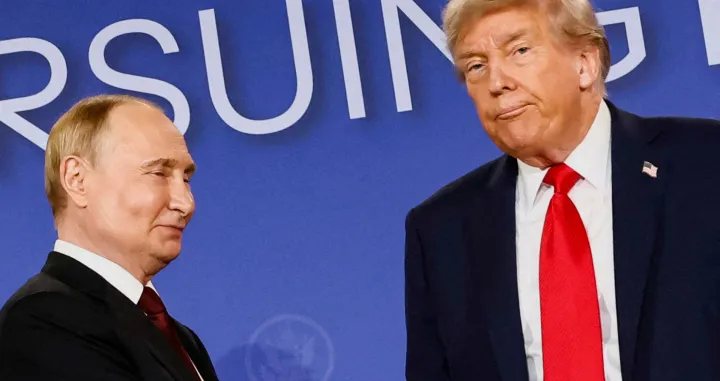 FILE PHOTO: U.S. President Donald Trump looks on next to Russian President Vladimir Putin during a press conference following their meeting to negotiate an end to the war in Ukraine, at Joint Base Elmendorf-Richardson, in Anchorage, Alaska, U.S., August 15, 2025. REUTERS/Kevin Lamarque  TPX IMAGES OF THE DAY/File Photo/Kevin Lamarque