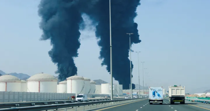 Smoke rises in the Fujairah oil industry zone, caused by debris after interception of a drone by air defenses, according to the Fujairah media office, amid the U.S.-Israel conflict with Iran, in Fujairah, United Arab Emirates, March 14, 2026. REUTERS/Staff/Staff