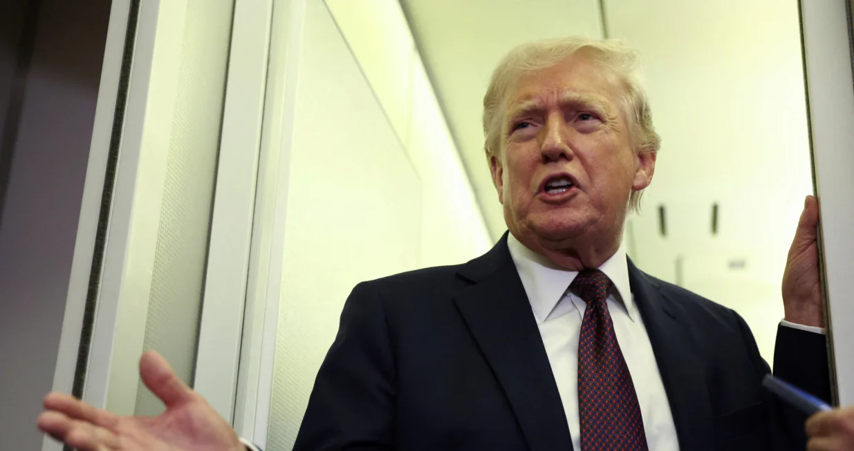 U.S. President Donald Trump speaks to reporters aboard Air Force One on a flight back to Washington March 15, 2026. REUTERS/Kevin Lamarque/Kevin Lamarque