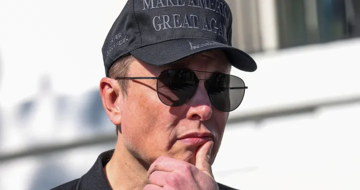 FILE PHOTO: Tesla CEO Elon Musk looks on next to U.S. President Donald Trump talking to the media, at the White House in Washington, D.C., U.S., March 11, 2025. REUTERS/Kevin Lamarque/File Photo/Kevin Lamarque