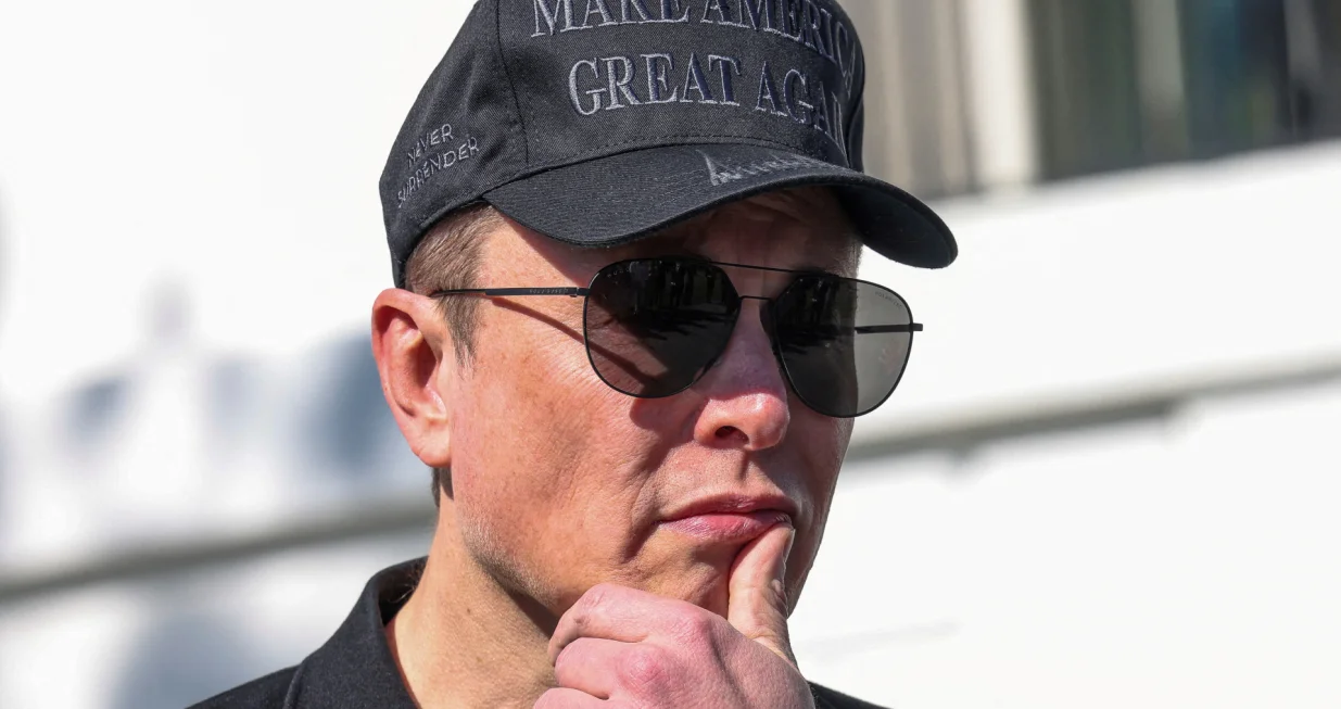 FILE PHOTO: Tesla CEO Elon Musk looks on next to U.S. President Donald Trump talking to the media, at the White House in Washington, D.C., U.S., March 11, 2025. REUTERS/Kevin Lamarque/File Photo/Kevin Lamarque
