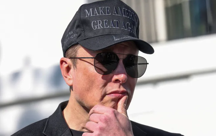 FILE PHOTO: Tesla CEO Elon Musk looks on next to U.S. President Donald Trump talking to the media, at the White House in Washington, D.C., U.S., March 11, 2025. REUTERS/Kevin Lamarque/File Photo/Kevin Lamarque