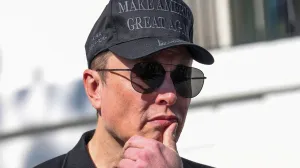 FILE PHOTO: Tesla CEO Elon Musk looks on next to U.S. President Donald Trump talking to the media, at the White House in Washington, D.C., U.S., March 11, 2025. REUTERS/Kevin Lamarque/File Photo/Kevin Lamarque
