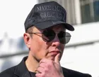 FILE PHOTO: Tesla CEO Elon Musk looks on next to U.S. President Donald Trump talking to the media, at the White House in Washington, D.C., U.S., March 11, 2025. REUTERS/Kevin Lamarque/File Photo/Kevin Lamarque